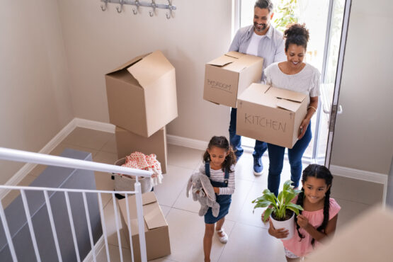 family-happily-moving-into-their-new-home family-happily-moving-into-their-new-home